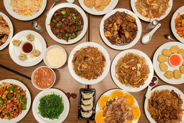 Dishes of food cooked in a Chinese restaurant, orange duck, wakame salad, rice noodles, udon noodles, beef with bamboo and mushrooms, beef with peppers, gyozas, three delights rice