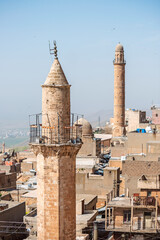 Fototapeta na wymiar Ancient red sandstone minarets in the stone city of Mardin, Turkey