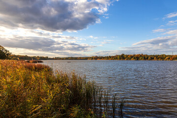 Hlohovecky Pond in Moravia in the Czech Republic. The sky is blue, the clouds white.