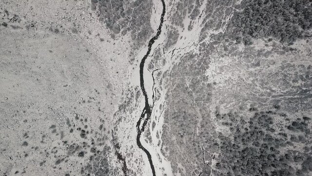Storm, snowfall in the huge glacier of Mount Belukha, the valley of the Aktru River, the Altai Mountains. Cloudy weather, stone in the snow, storm, wildlife, winter forest, frozen mountain river in
