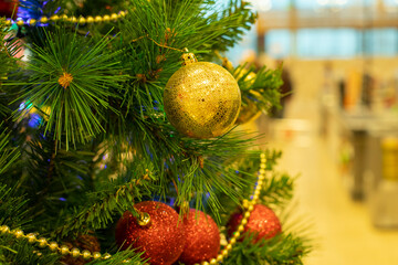 Christmas tree branch with toy red gold ball and garland