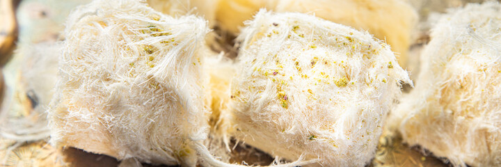 pismaniye Turkish sweet with nuts and pistachio dessert sweet a portion ready to eat meal snack on the table copy space food background rustic. top view