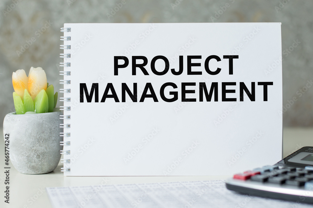 Poster project management memo written on a notebook on the table