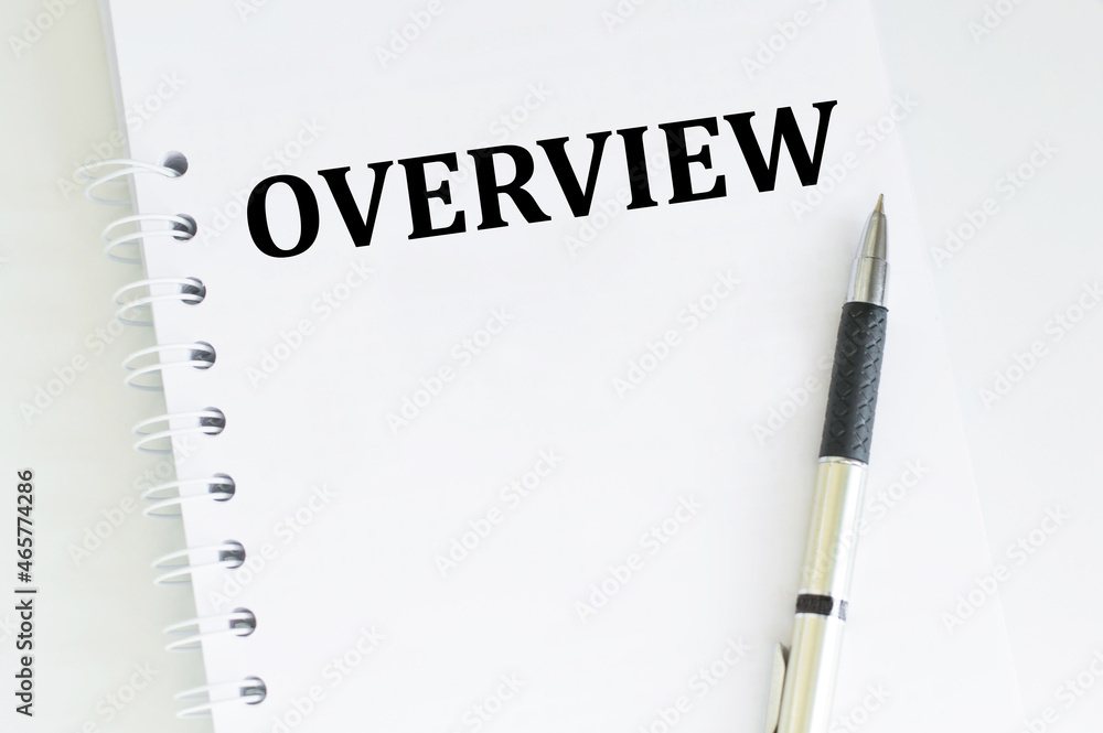 Aufkleber overview text on a white notepad on a white background near is a pen