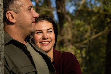 Obraz premium Beautiful young couple in autumn forest on a sunny day
