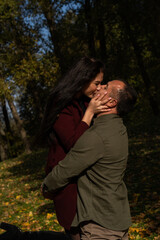 Beautiful young couple in autumn forest on a sunny day