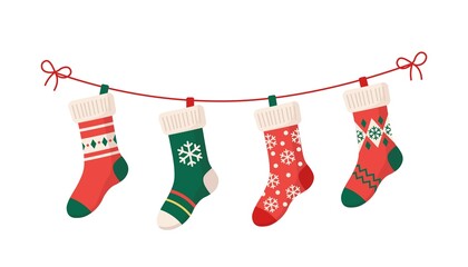 Christmas stockings with various traditional colorful holiday ornaments. Hanging children clothing elements with cute xmas patterns on rope. Red, green socks with snowflakes, snowman, christmas tree