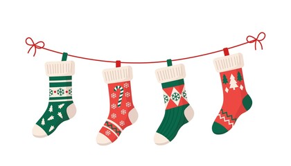 Christmas stockings with various traditional colorful holiday ornaments. Hanging children clothing elements with cute xmas patterns on rope. Red, green socks with snowflakes, snowman, christmas tree