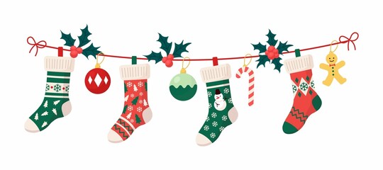 Christmas stockings with traditional holiday ornaments, decoration balls, gingerbread man. Hanging children clothing elements with xmas patterns on rope. Socks with snowflakes, snowman, christmas tree
