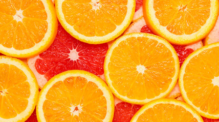 Banner with sliced grapefruit and orange. Sliced citrus fruits top view, healthy food background