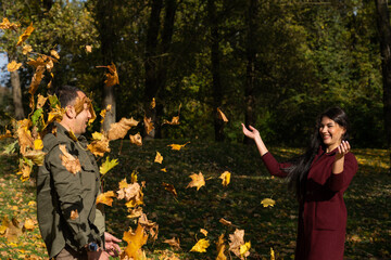 Beautiful young couple in autumn forest on a sunny day