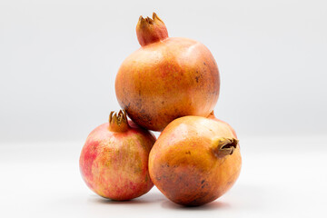 Fresh organic pomegranate fruits on a white background with shadow. close up
