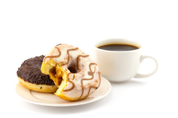 Still life with bitten caramel striped donut on plate and cup of black coffee isolated on a white background. Concept background of world problem of obesity and unhealthy nutrition