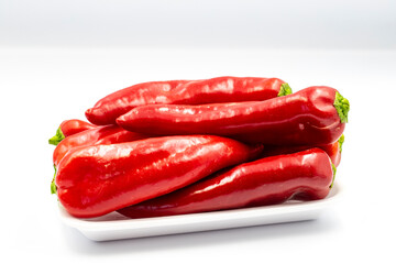 Packed fresh red pepper on white background with shadow. close up