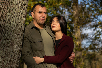 Beautiful young couple in autumn forest on a sunny day