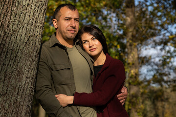 Beautiful young couple in autumn forest on a sunny day