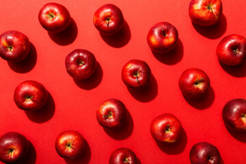 Many red apples on colored background, top view. Autumn pattern with fresh apple above view