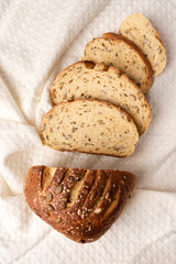 sliced wheat bread with seeds in paper packaging