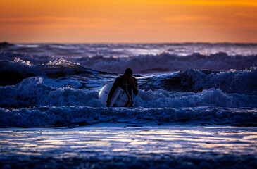 Surfer silhouette in Cortadura's Beach in Cadiz, Spain.