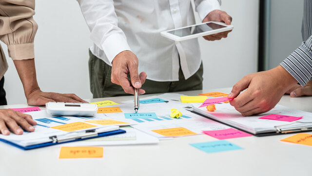 Business people team, businessman holding tablet to looking for checking data and pointing post it notes