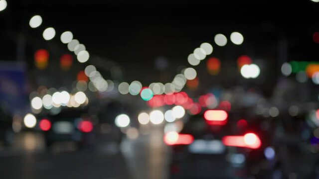 defocused background of generic night car traffic in city streets