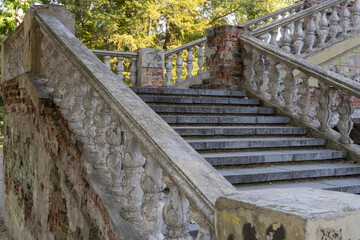 Close-up ancient stone railings. Old classic balustrade. Disrupted stairs. Details of the architecture.