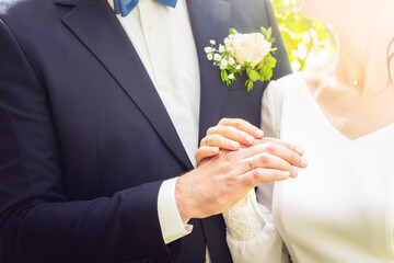 Close up view male and female hands hold with wedding rings .Classical style weds . Relationships bond and wedding styles concept