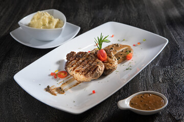 close up view of nice yummy pork chop on grey background