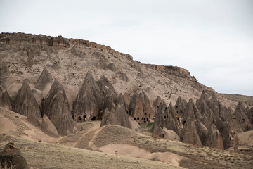 landscape in the desert with rock homes in Cappadocia