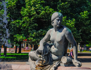 The famous water fountain Neptune Statue. Here the woman pouring water