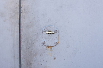 Metal garage door with keyhole. Keyhole on metal gate