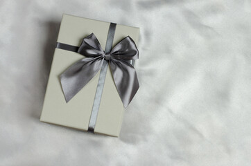 Gift box on silk fabric, dark green tint. Valentine or birthday gift. Christmas gift with place for text
