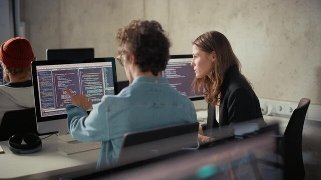 Smart Young Students Studying in University with Diverse Multiethnic Classmates. Scholars Collaborate in College Room on Computer Science Project, Writing Software Code in Successful Teamwork.