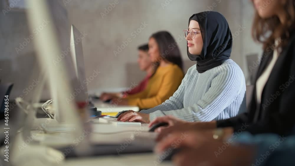 Aufkleber Happy Female Muslim Student Wearing a Hijab, Studying in Modern University with Diverse Multiethnic Classmates. She Asks Scholar a Question in College Room. Learning Programming or Computer Science.