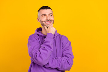 Photo of young minded dreamy creative man good mood look empty space idea isolated on yellow color...