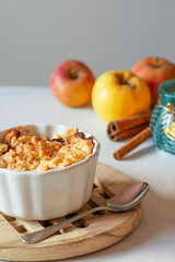 Apples with cinnamon crumble. Hot autumn dessert. Autumn fruits. Autumn afternoon.