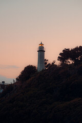 A beautiful night sky behind a shining lighthouse