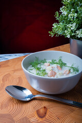 Traditional Finnish cuisine: Bowl of creamy salmon soup with dill topping.