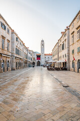Fototapeta premium Dubrovnik main street - Strada street. Main shopping street in old city of Dubrovnik. Morning time during the sunset, soft light and warm colors. Ancient city, part of UNESCO heritage.