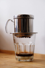 Making coffee in a Vietnamese phin with condensed milk in a glass