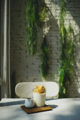 cup of coffee with milk and sweeten silk candy.