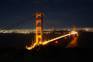 Golden Gate Bridge is illuminated during night