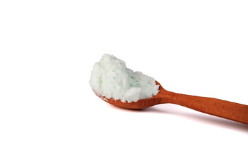 Body scrub with green crystals in wooden spoon. Homemade cosmetic for peeling and spa care. Isolated on white.