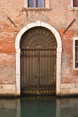 Venice wood ancient door on the water