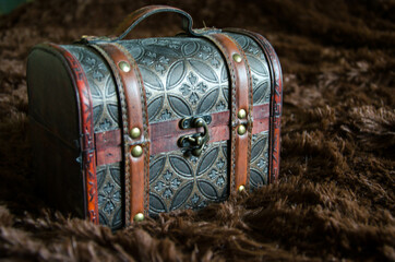 old chest, small box for jewelry, on a dark background