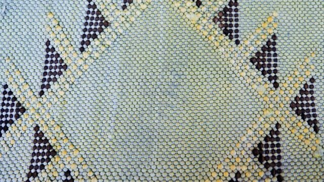 Detail of a handmade, traditional, Moroccan cactus silk (Sabra silk) rug, carpet, mint green. Macro closeup abstract geometric patterns.