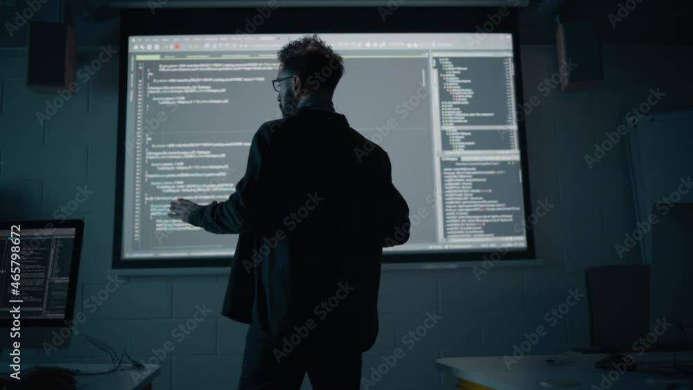Aufkleber Teacher Giving Computer Science Lecture to Diverse Multiethnic Group of Female and Male Students in Dark College Room. Projecting Slideshow with Programming Code. Explaining Information Technology.