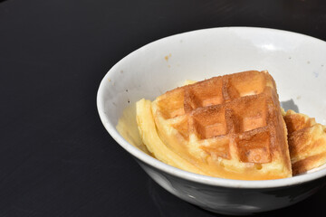 fresh waffle on plate on the black backgrounds