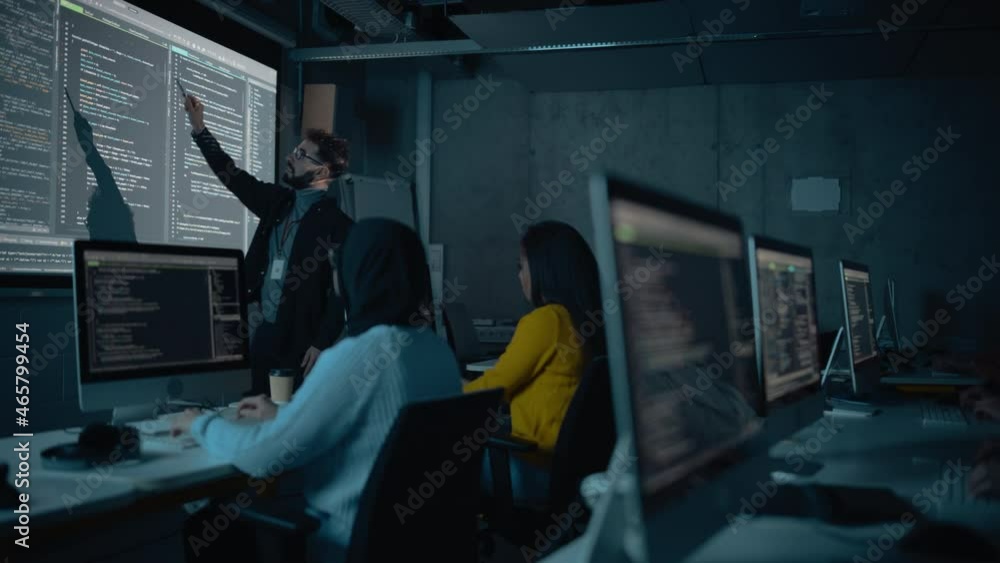 Fototapete Teacher Giving Computer Science Lecture to Diverse Multiethnic Group of Female and Male Students in Dark College Room. Projecting Slideshow with Programming Code. Explaining Information Technology.