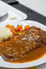 A delicious western-style meat sauce steak with mashed potatoes